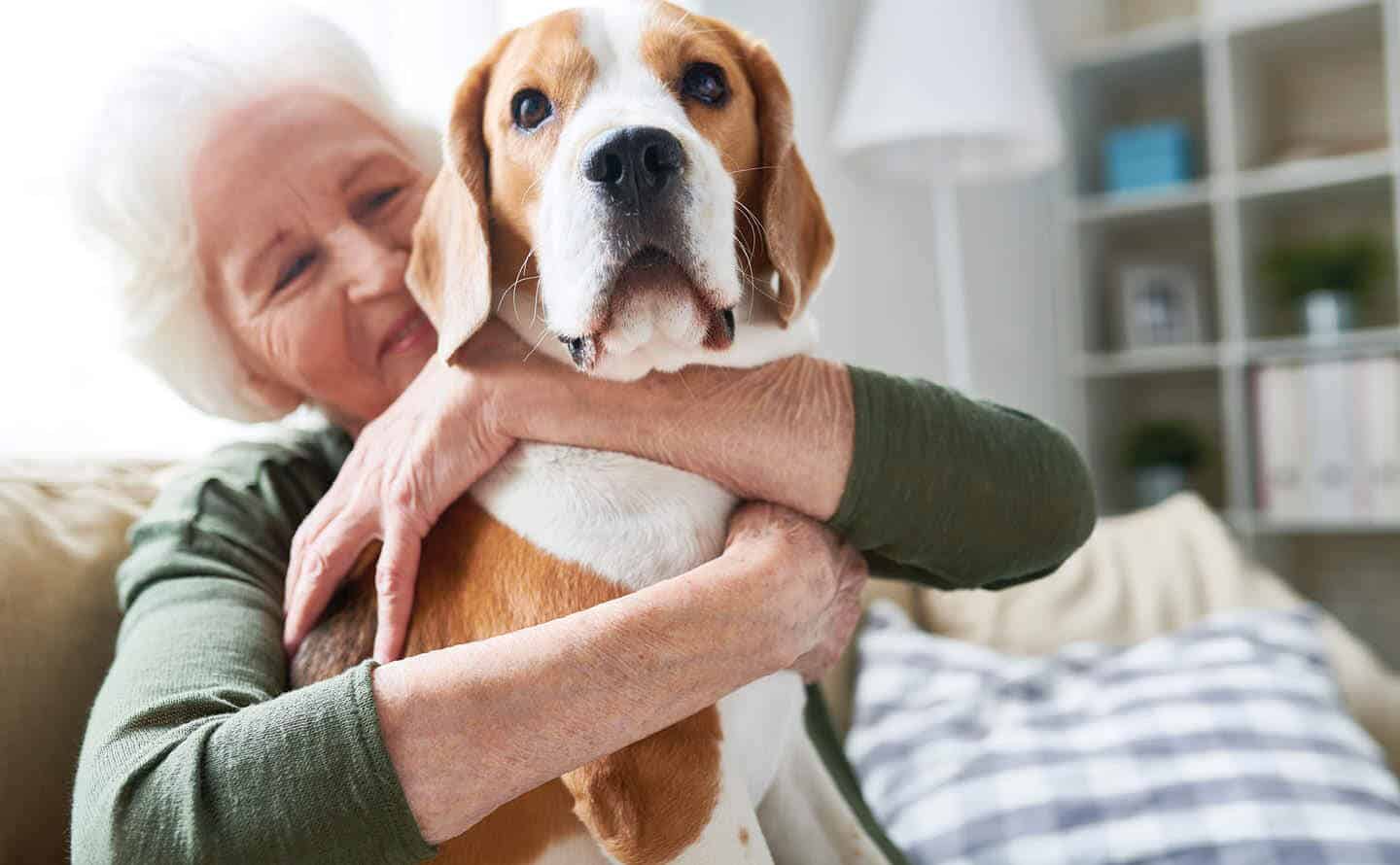 elderly woman hugging her dog