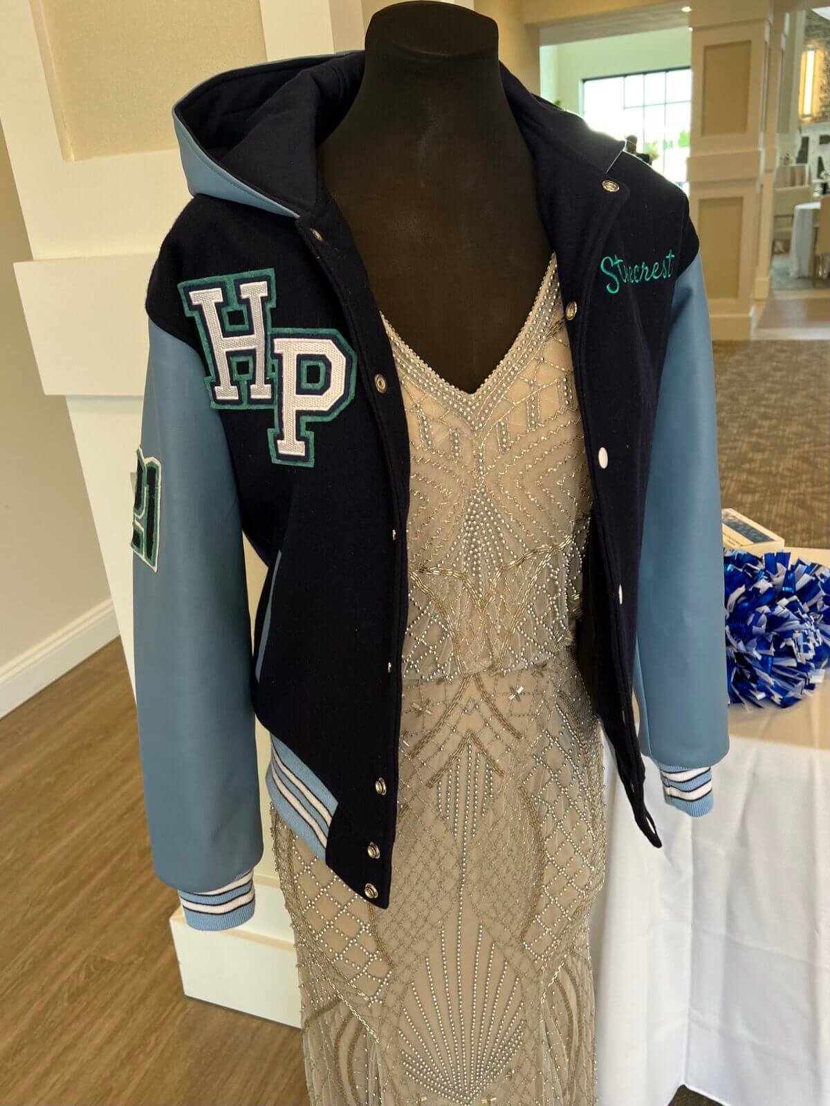 mannequin displaying dress and letter jacket