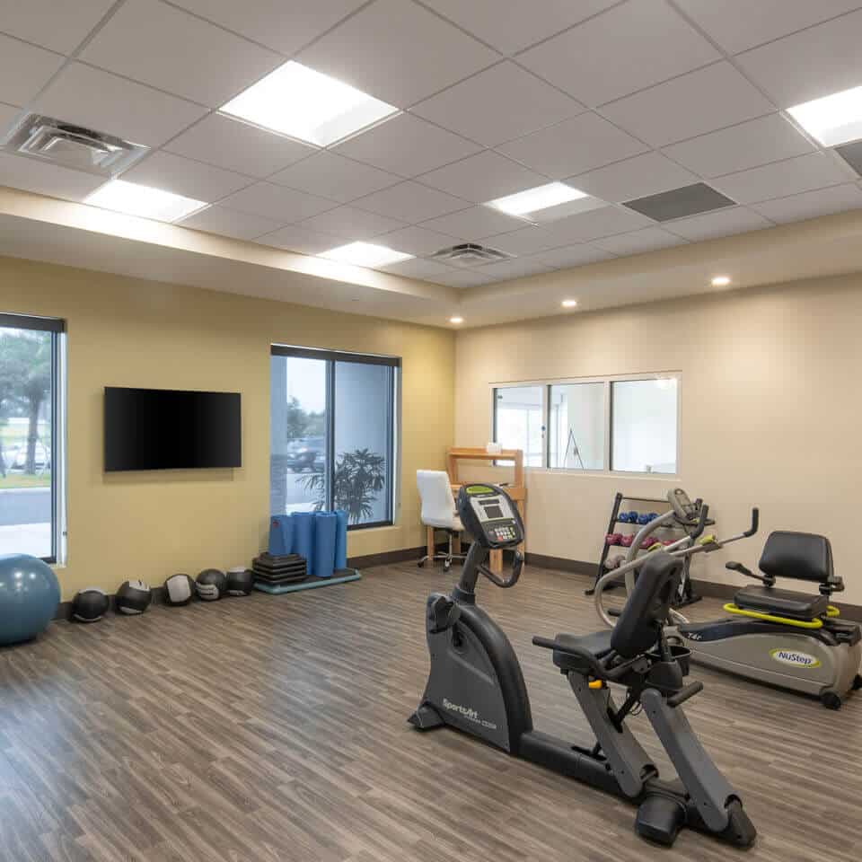 fitness room with bike and weights