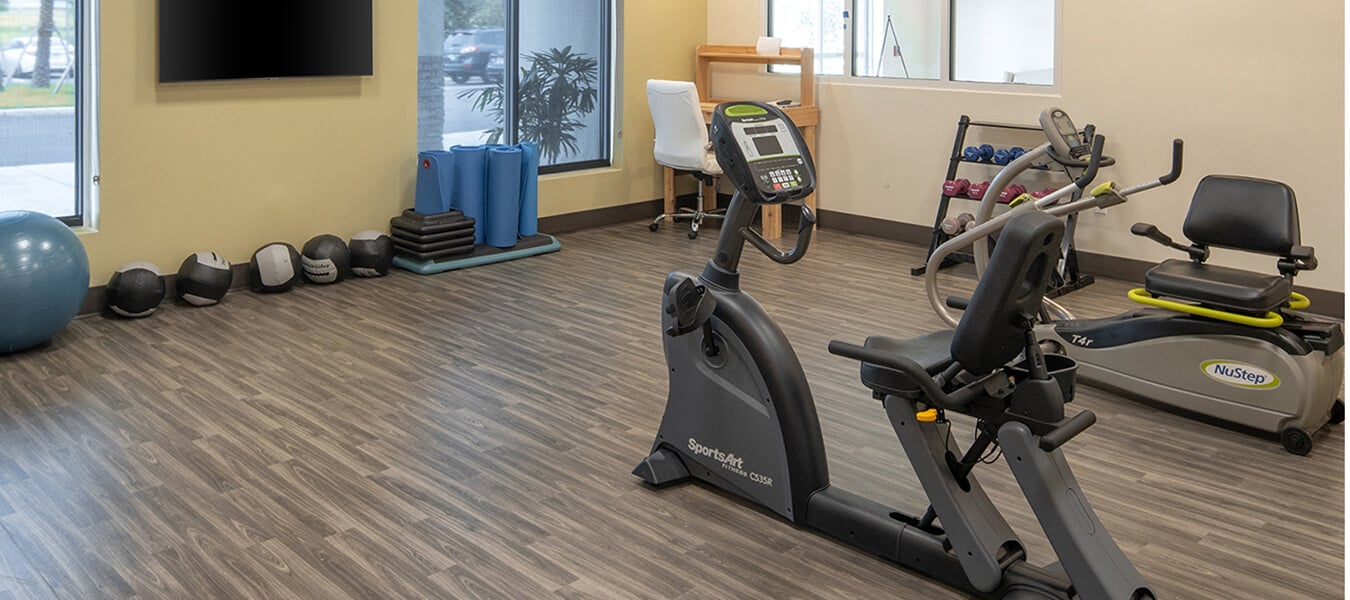 fitness room with bike and weights