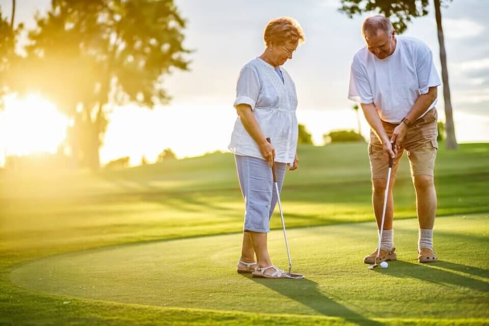 senior couple enjoying a game of golf